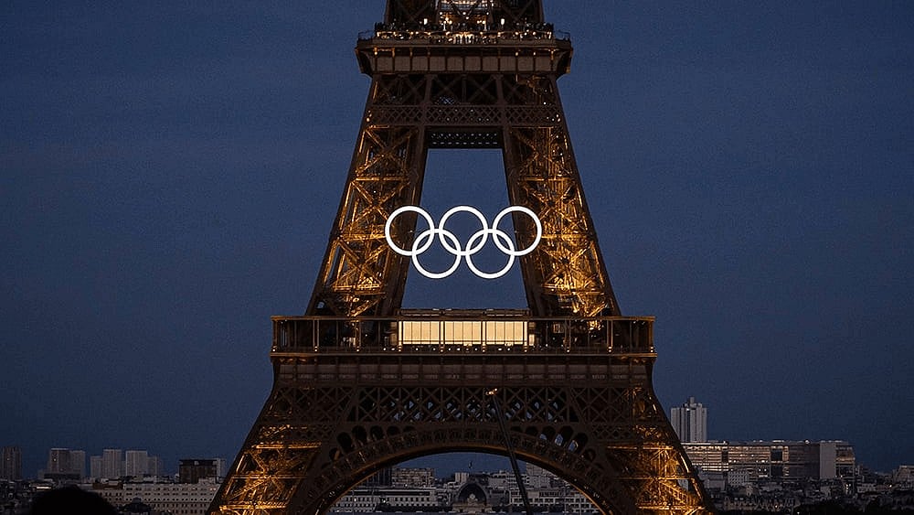 Photo: AP/Aurelien Morissard : The Eiffel Tower shines brighter than ever, adorned with the Olympic spirit.
